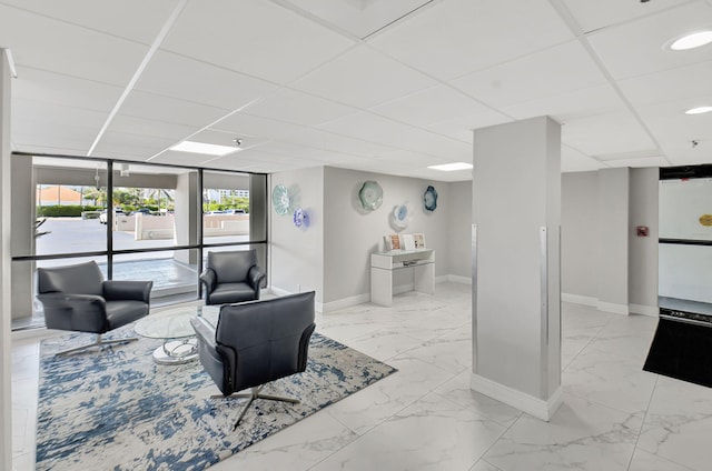 living room with a drop ceiling