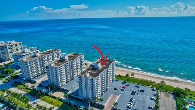 aerial view with a water view and a beach view