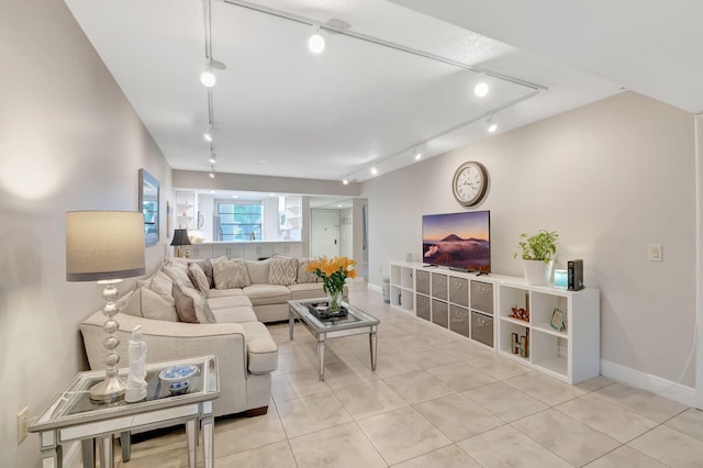 tiled living room featuring rail lighting