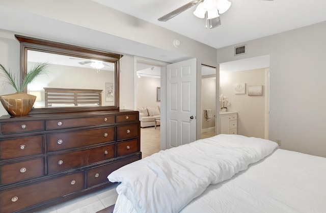 tiled bedroom featuring ceiling fan