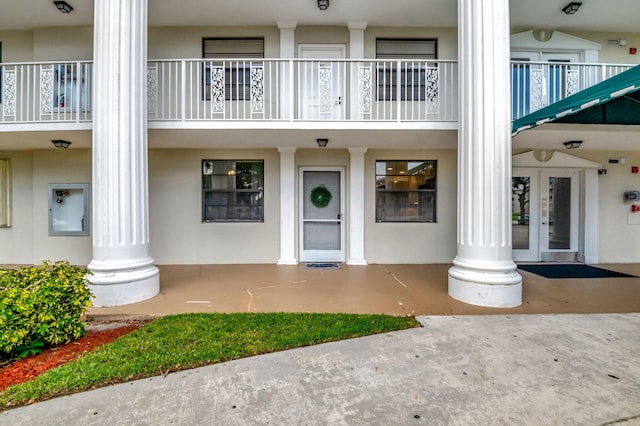 entrance to property with a balcony and french doors