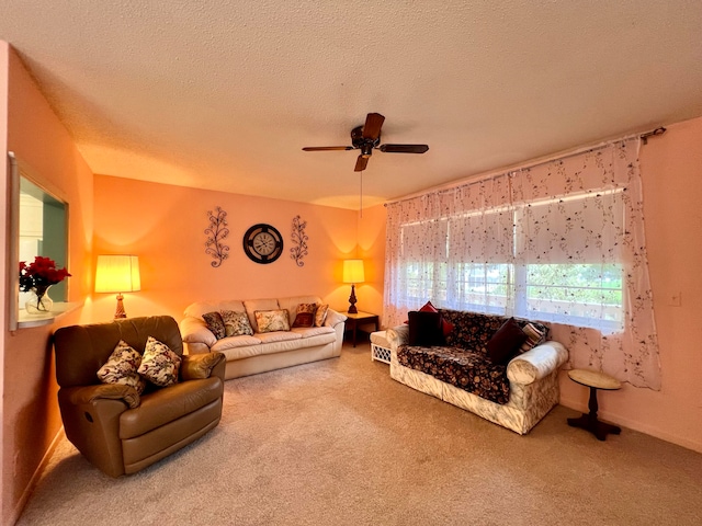 carpeted living room with a textured ceiling and ceiling fan