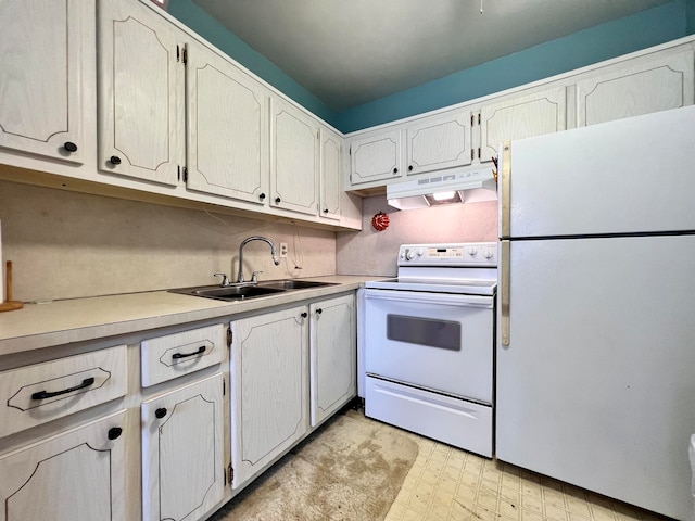 kitchen with white appliances, sink, and white cabinets