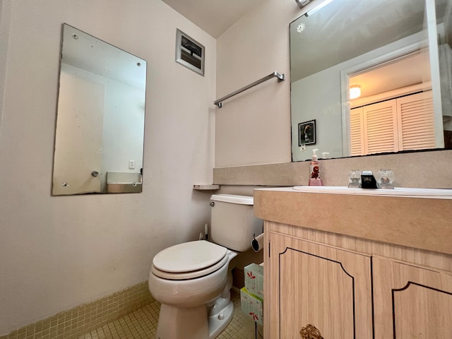 bathroom with vanity, toilet, and tile patterned flooring