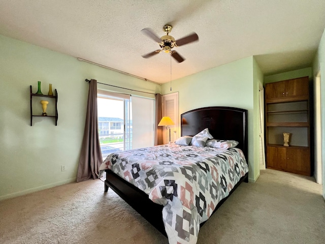 bedroom with light carpet, a textured ceiling, and ceiling fan