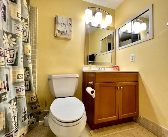 bathroom featuring tile patterned floors, toilet, and vanity