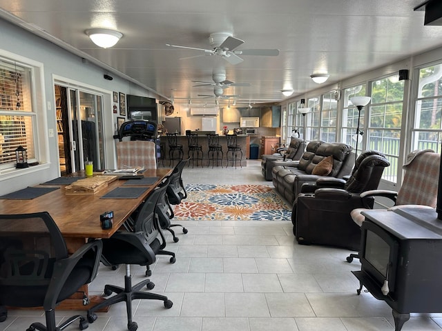 sunroom featuring ceiling fan