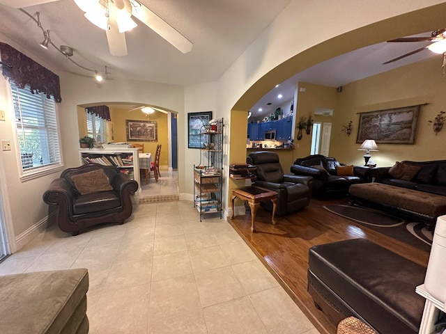 living room with light hardwood / wood-style flooring and ceiling fan