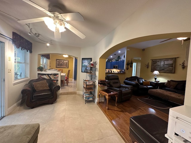 living room with ceiling fan and light hardwood / wood-style flooring