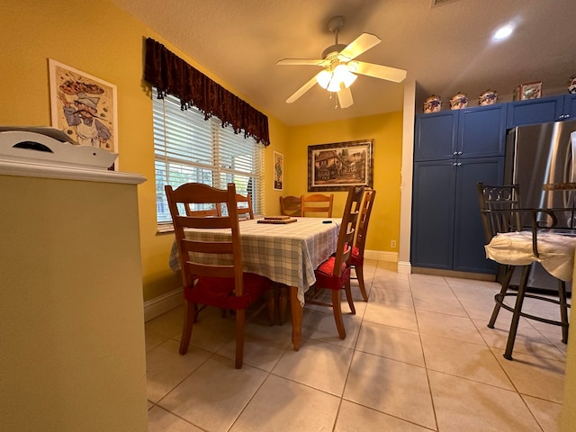 dining room with light tile patterned floors and ceiling fan