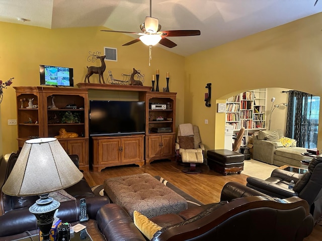 living room with lofted ceiling, ceiling fan, and wood-type flooring