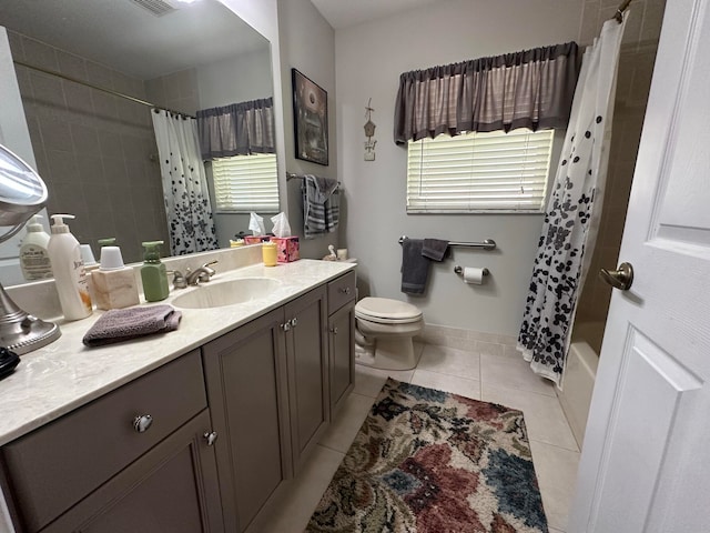 full bathroom featuring shower / bath combo with shower curtain, toilet, plenty of natural light, and vanity