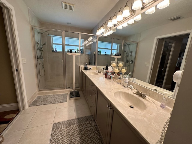 bathroom with vanity, a wealth of natural light, and walk in shower