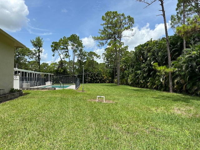 view of yard with a fenced in pool