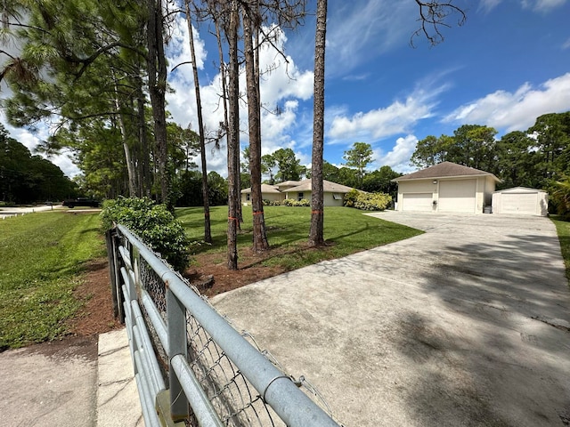 view of front of property featuring an outbuilding, a front yard, and a garage