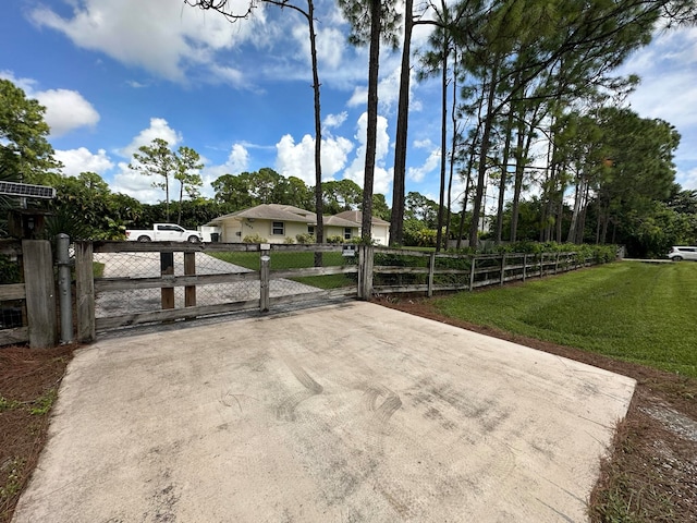 view of gate featuring a lawn