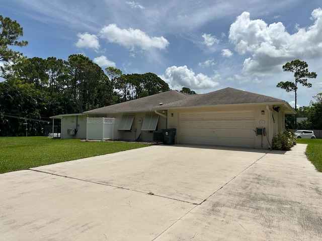 ranch-style house with a garage and a front lawn