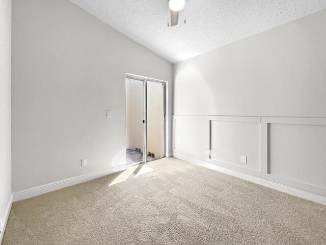 interior space featuring lofted ceiling, ceiling fan, and light carpet