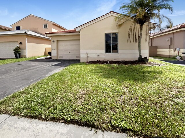 view of front of home featuring a garage and a front yard