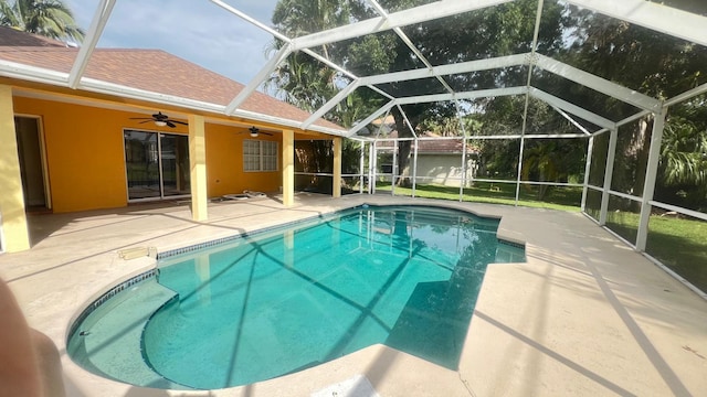 view of pool featuring a lanai, ceiling fan, and a patio