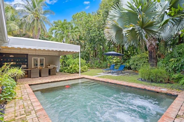 view of swimming pool with an outdoor hangout area and grilling area