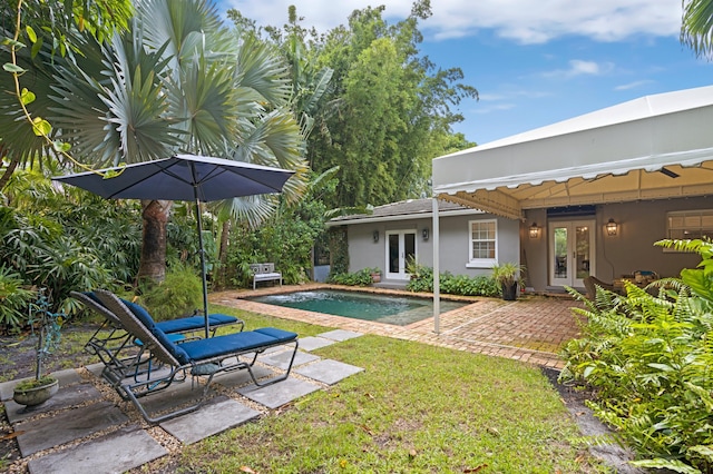 view of yard featuring a patio area and french doors