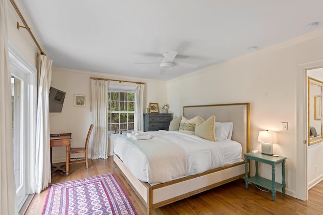 bedroom featuring ceiling fan, hardwood / wood-style floors, and crown molding