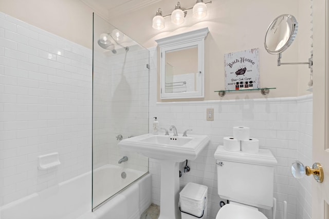 bathroom featuring crown molding, tiled shower / bath combo, tile walls, and toilet