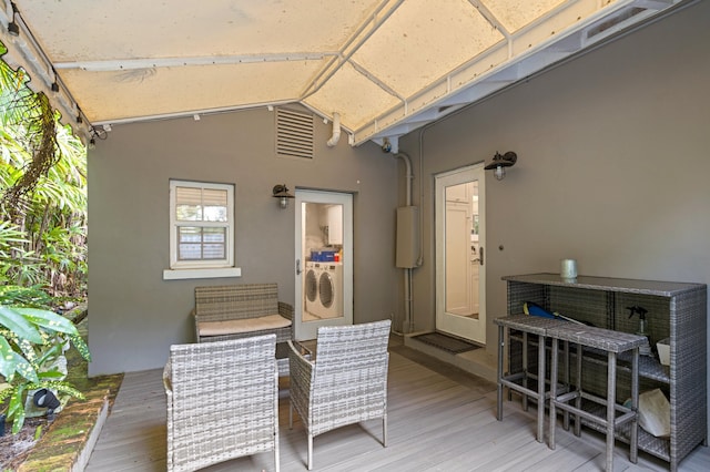 view of patio with a deck and separate washer and dryer