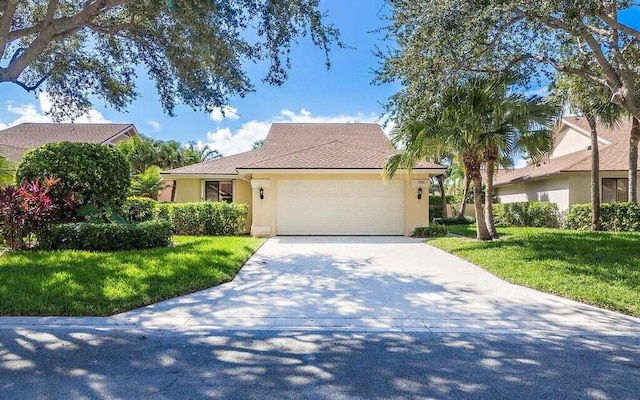 view of front of home with a garage and a front yard