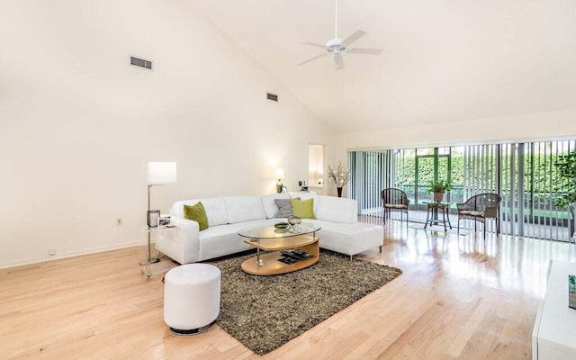 living room featuring ceiling fan, high vaulted ceiling, and hardwood / wood-style floors