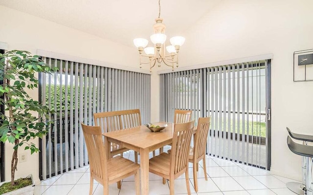 tiled dining room with an inviting chandelier and a healthy amount of sunlight