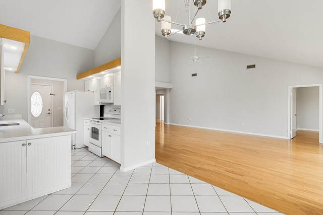 kitchen featuring ceiling fan with notable chandelier, white cabinets, white appliances, and light hardwood / wood-style floors