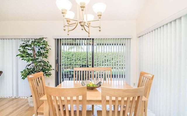 dining area featuring a chandelier and hardwood / wood-style floors