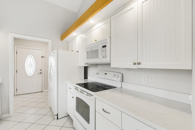 kitchen featuring light tile patterned flooring, white appliances, white cabinetry, and vaulted ceiling