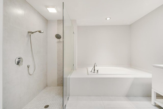 bathroom featuring tile patterned floors and shower with separate bathtub