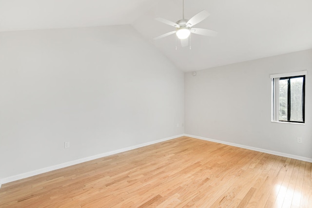 empty room featuring lofted ceiling, ceiling fan, and light wood-type flooring