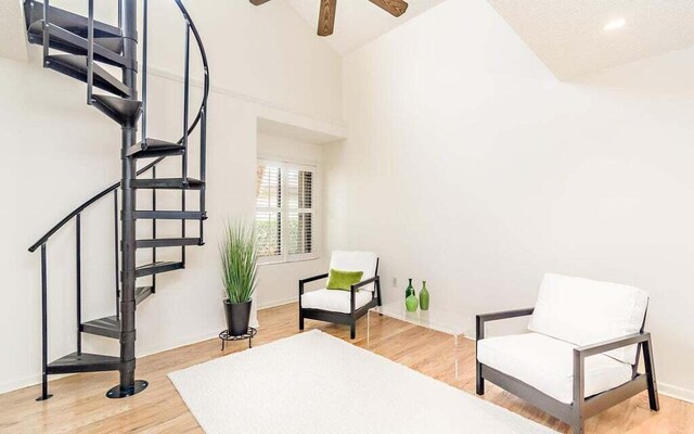 sitting room featuring hardwood / wood-style flooring, lofted ceiling, and ceiling fan