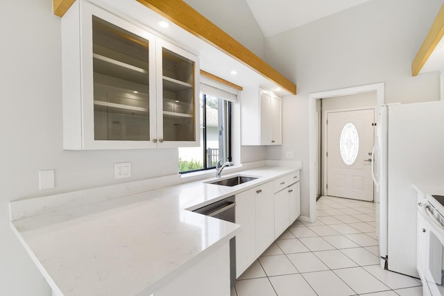 kitchen featuring white cabinetry, white appliances, sink, and light tile patterned floors