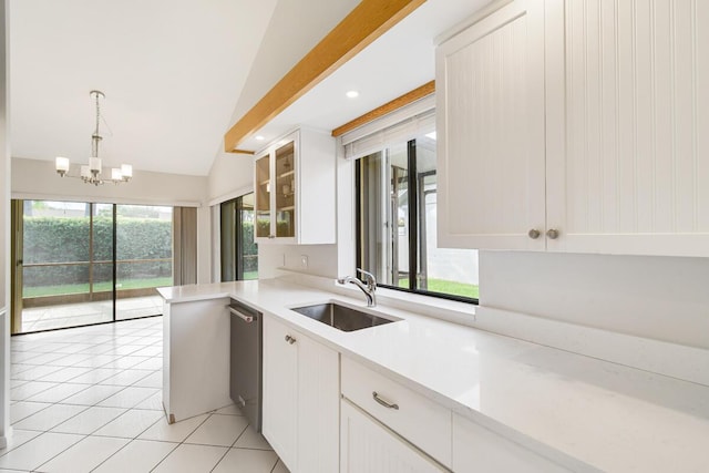 kitchen with decorative light fixtures, dishwasher, sink, white cabinets, and light tile patterned floors