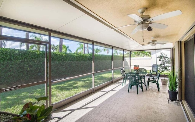 sunroom featuring ceiling fan