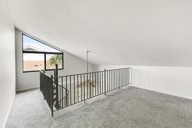 additional living space with lofted ceiling and carpet flooring