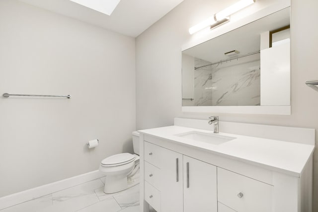 bathroom featuring vanity, toilet, a shower, and a skylight