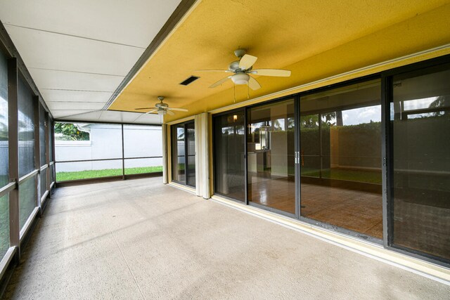 unfurnished sunroom featuring ceiling fan