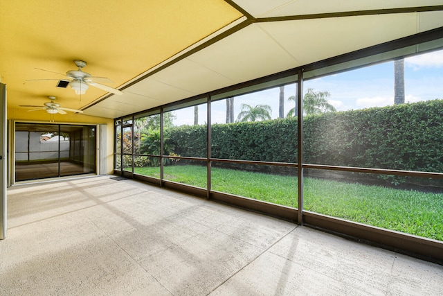 unfurnished sunroom with ceiling fan