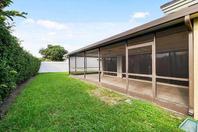 view of yard with a sunroom and a patio area