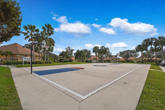 view of basketball court with a lawn