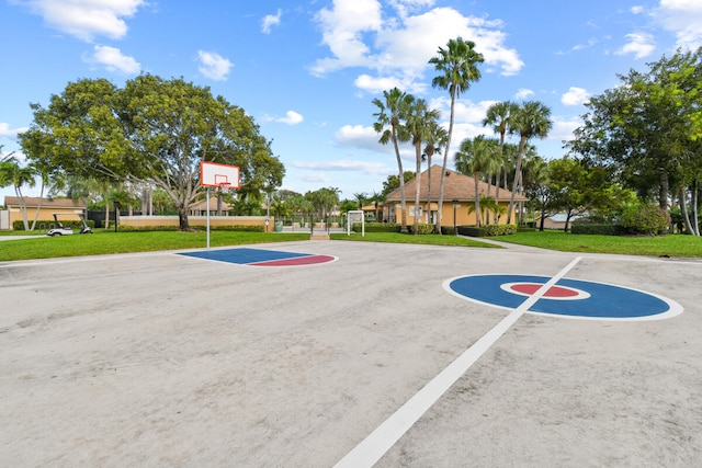 view of sport court with a lawn