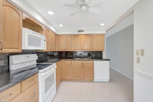 kitchen with white appliances, light brown cabinetry, dark stone countertops, light tile patterned floors, and ceiling fan