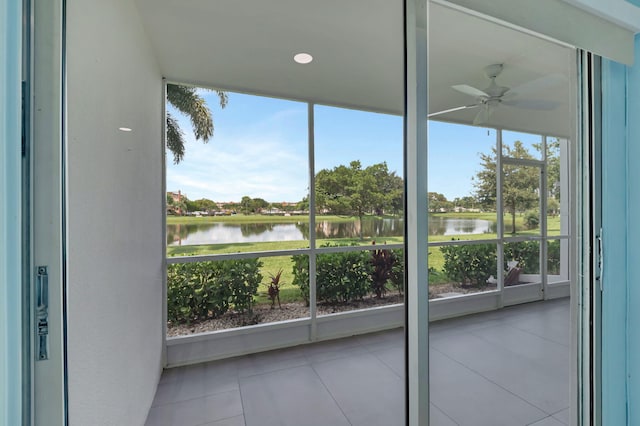 balcony with a water view and ceiling fan